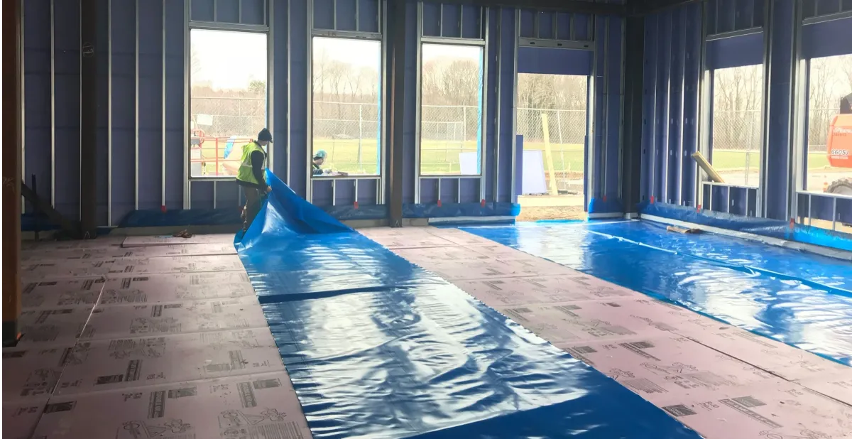 Moisture testing equipment and vapor barrier on a concrete basement floor