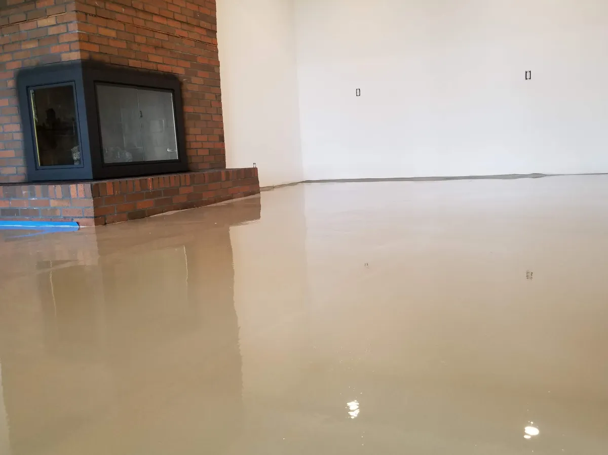 Cementitious self-leveling underlayment poured to ANSI flatness tolerance for large-format tile